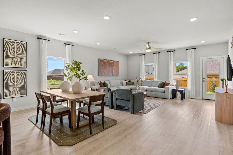 A large living room with a dining table and chairs.