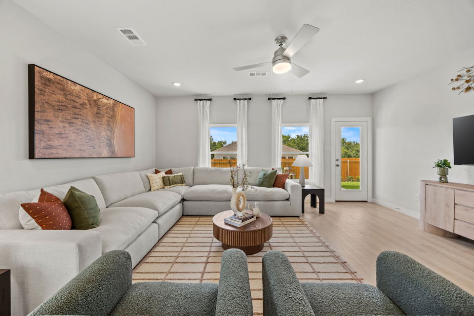 A living room with a large white couch and a large chandelier.