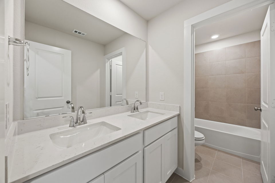 A bathroom with a tub sink and toilet.