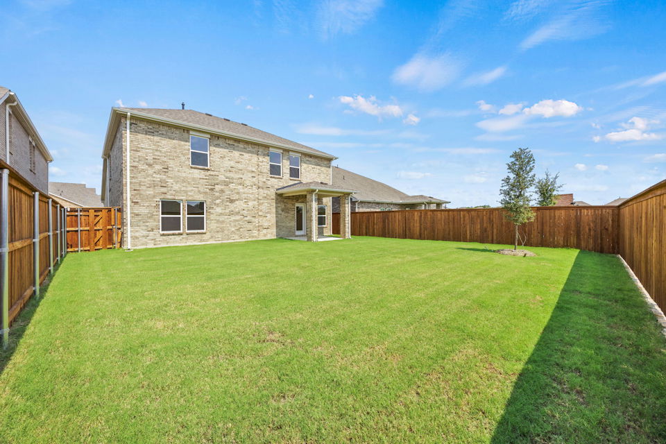 A house with a fence and grass.