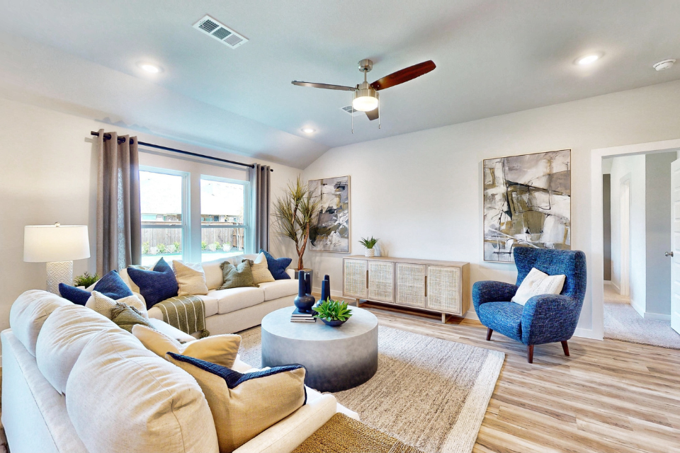 A living room with a large chandelier and a large window.