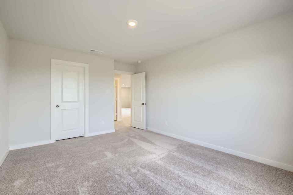 A hallway with white doors.