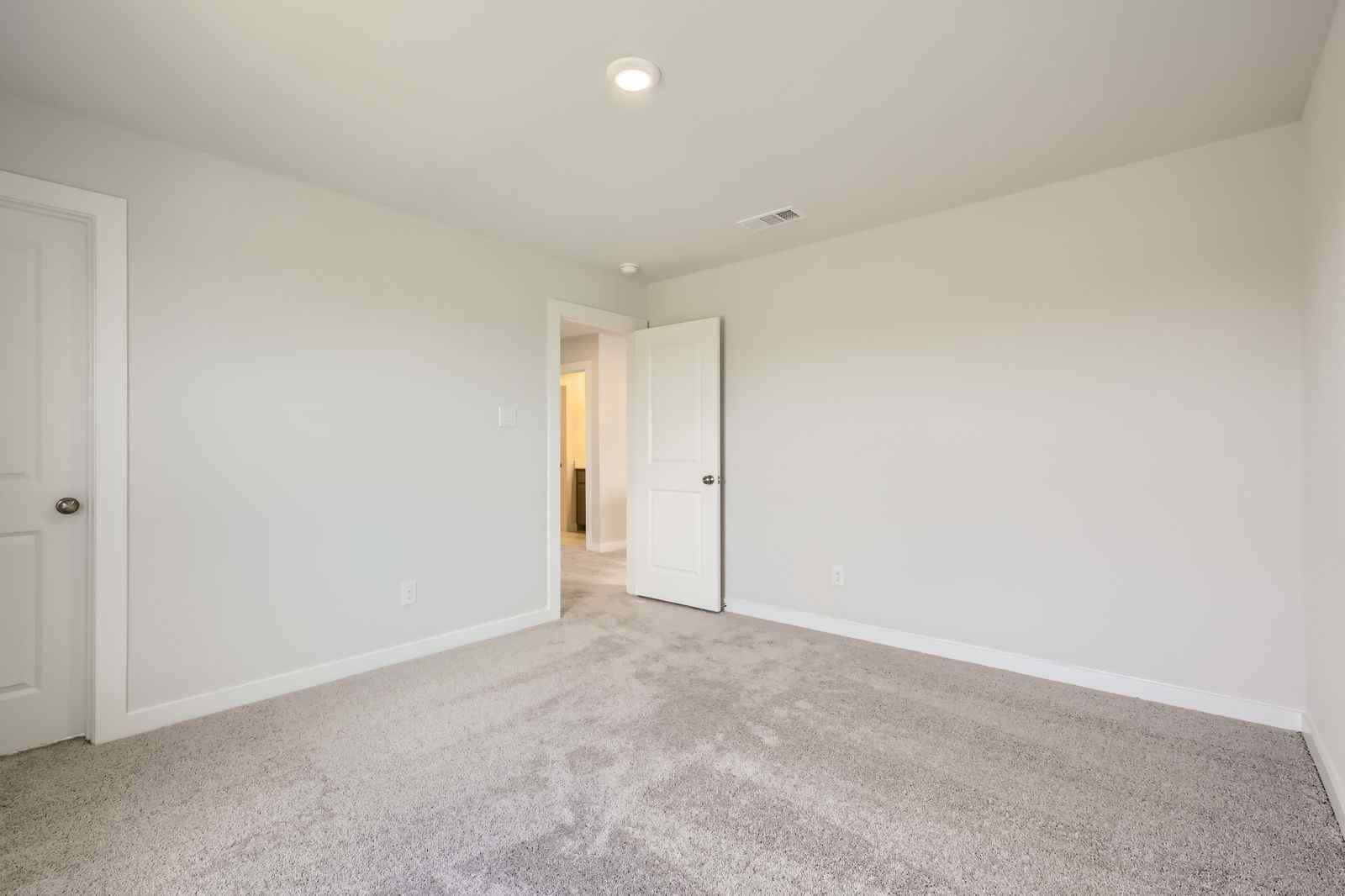 A hallway with white doors.