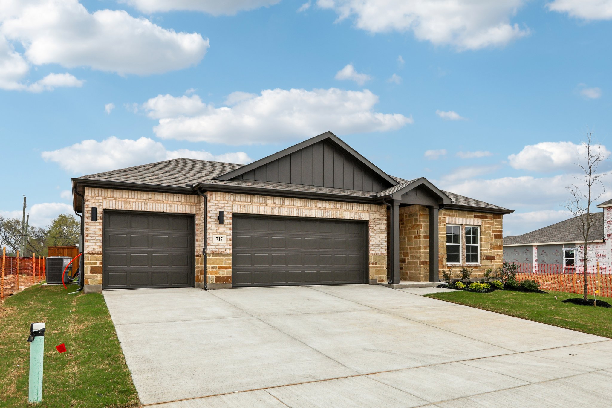 A house with garages and a driveway.