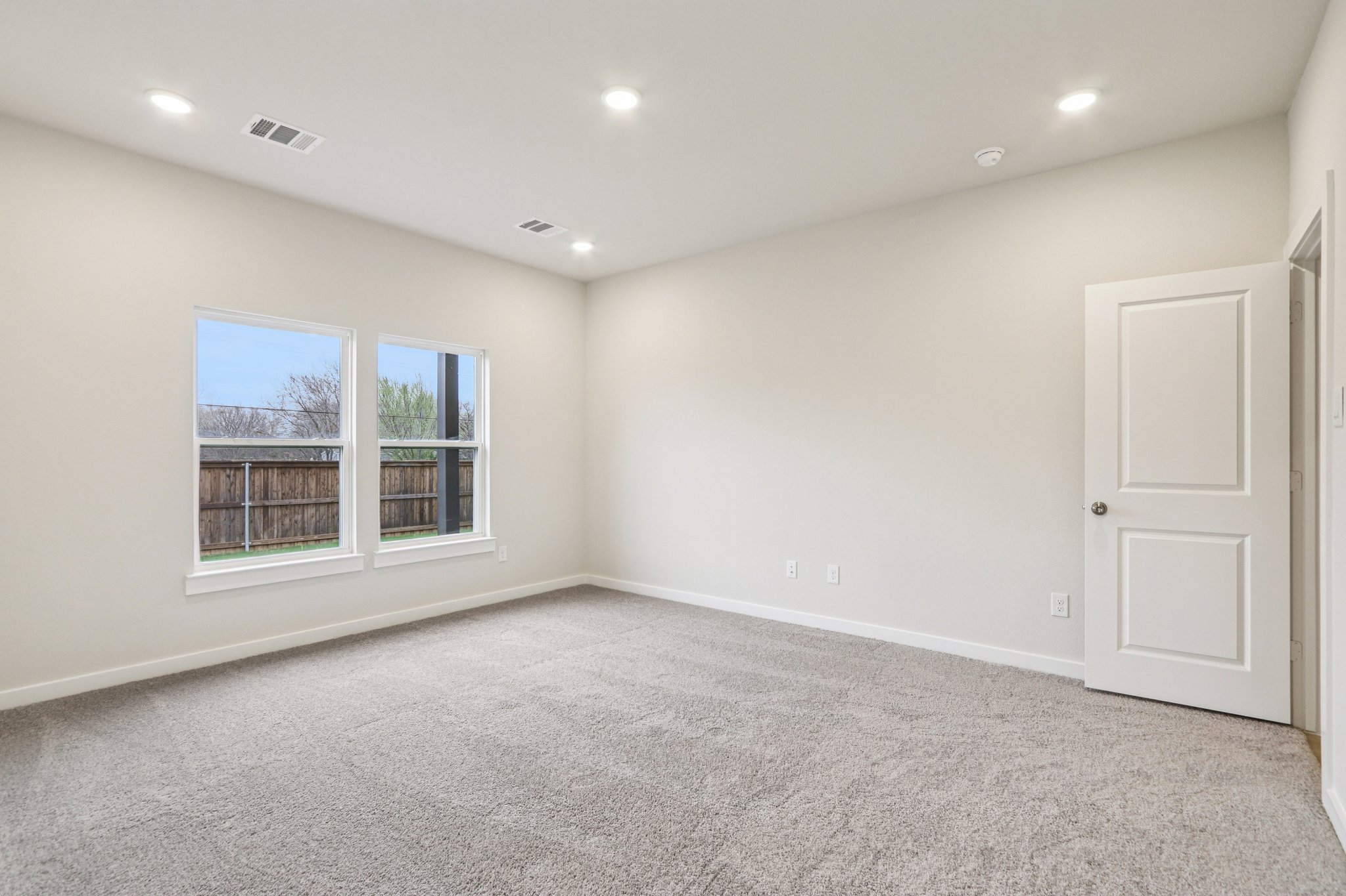 A room with a window and a door.