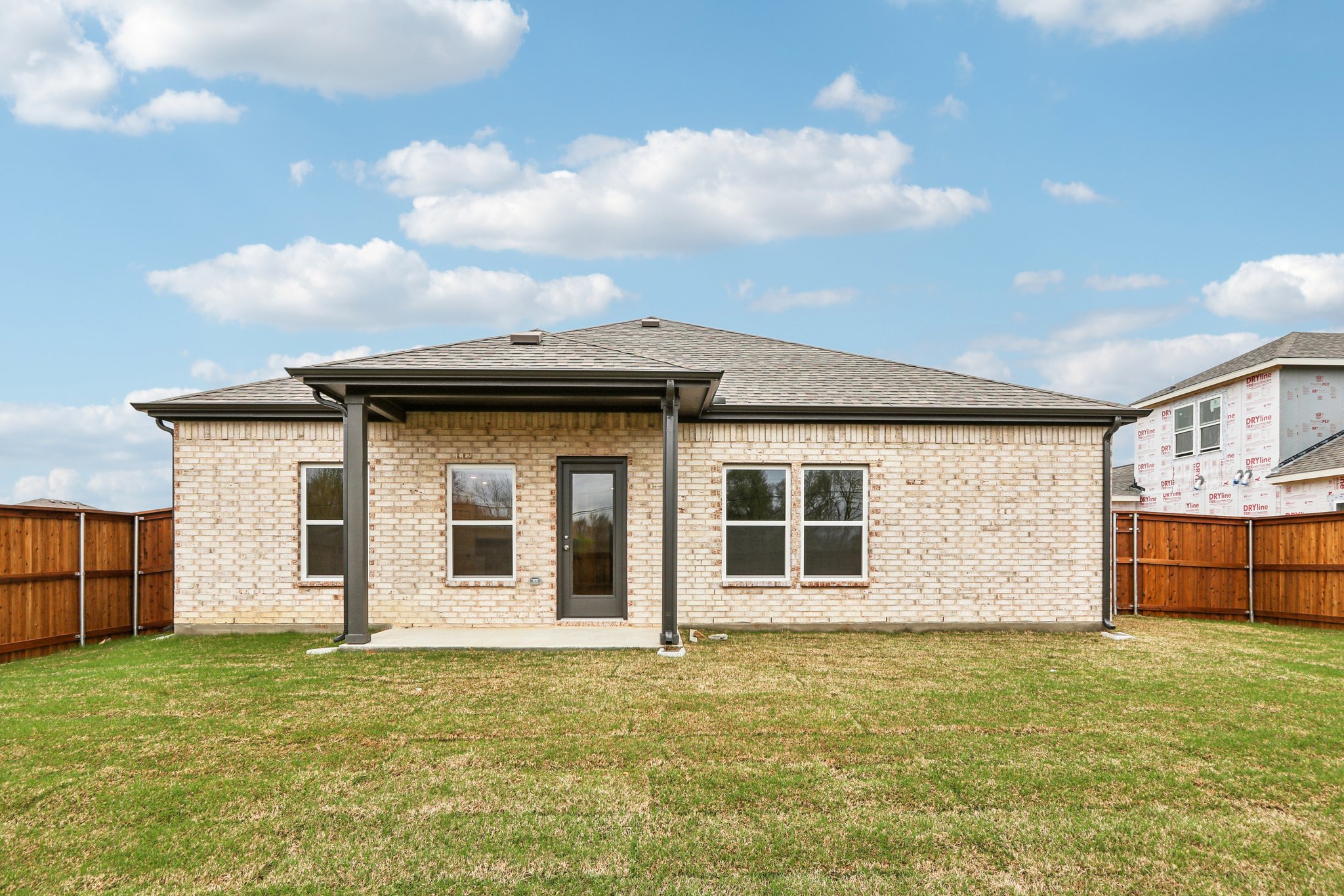 A brick house with a fence.