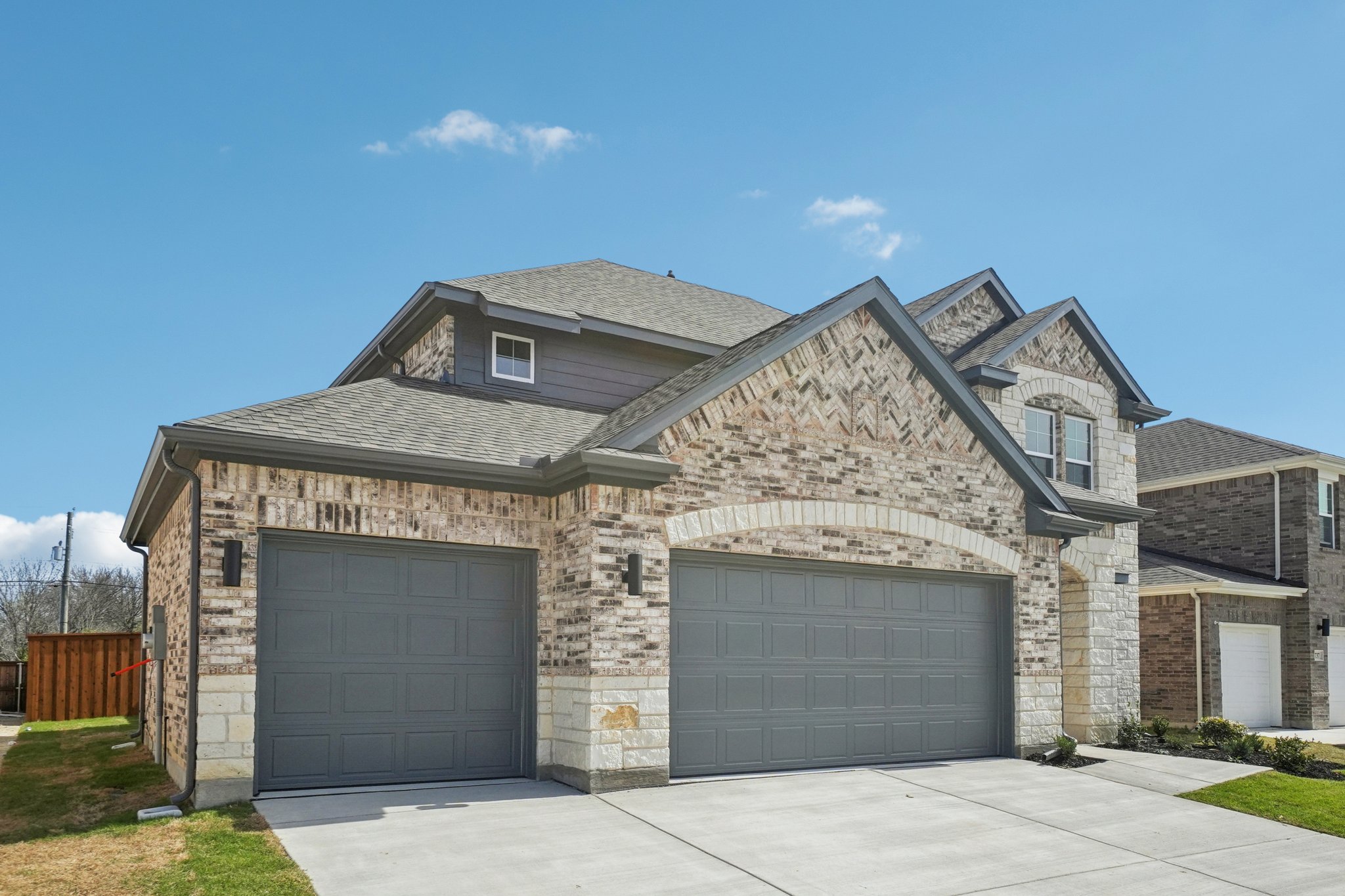 A stone building with garages.