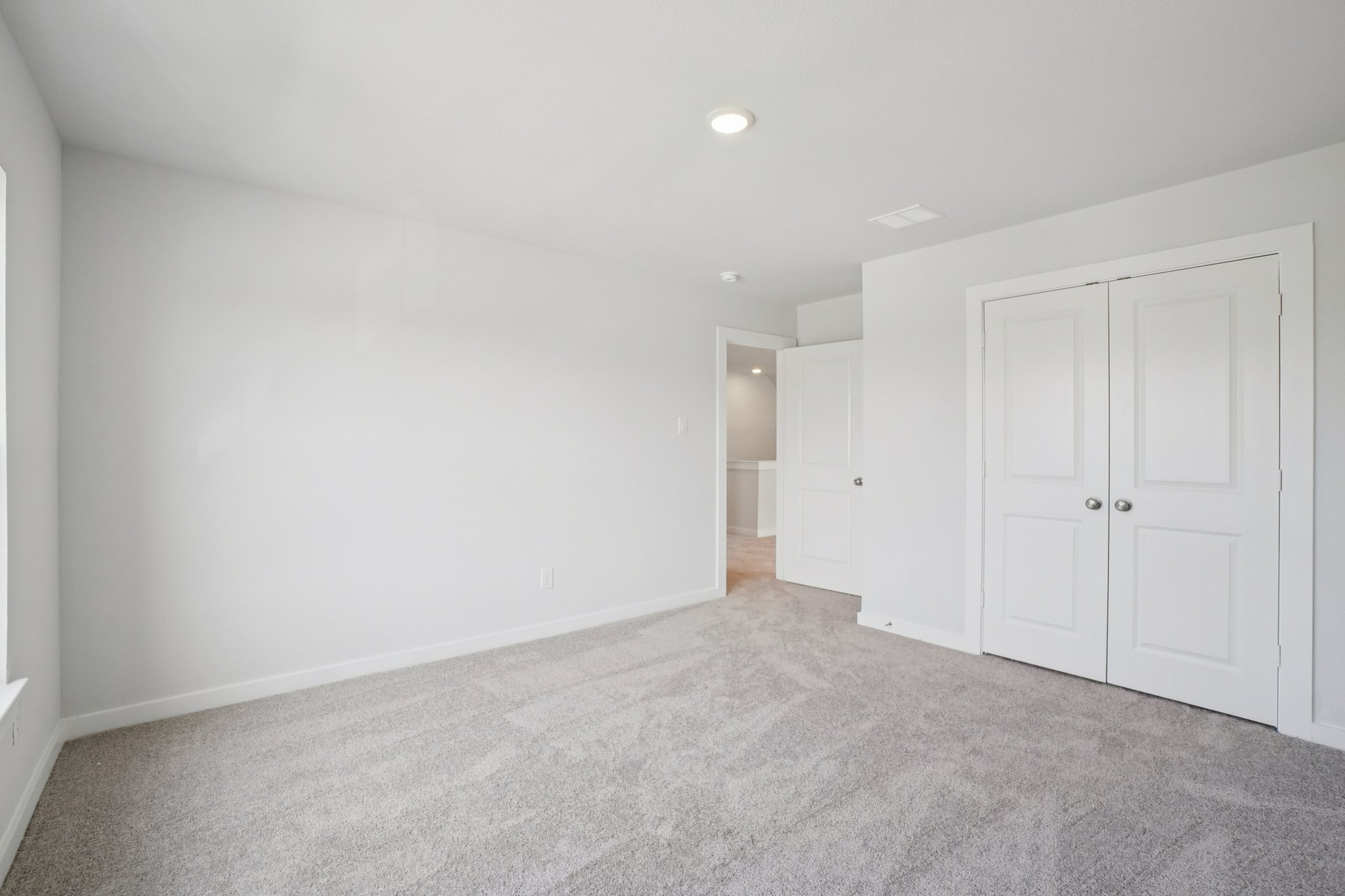 A hallway with white doors.