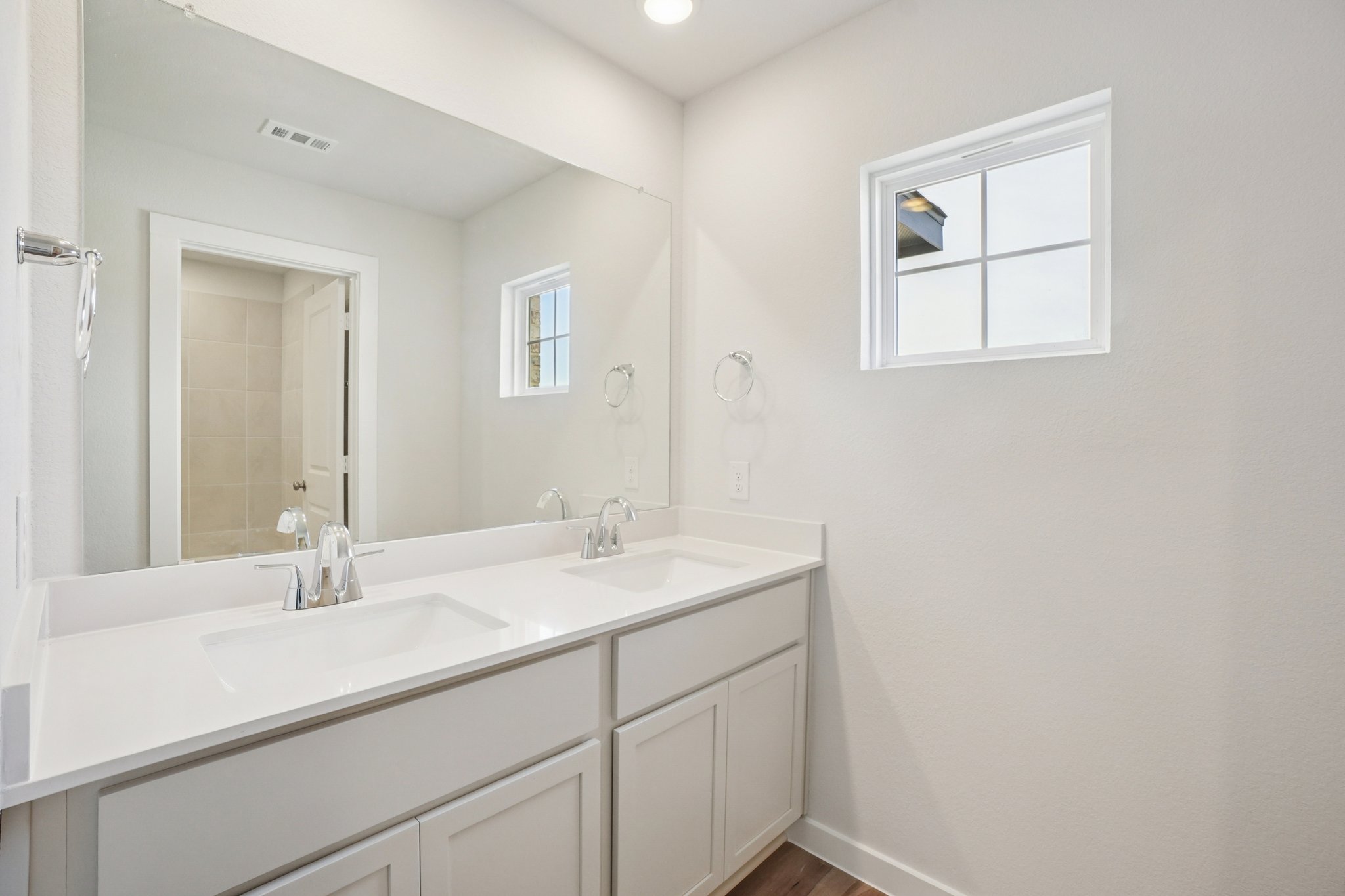 A bathroom with a large mirror.