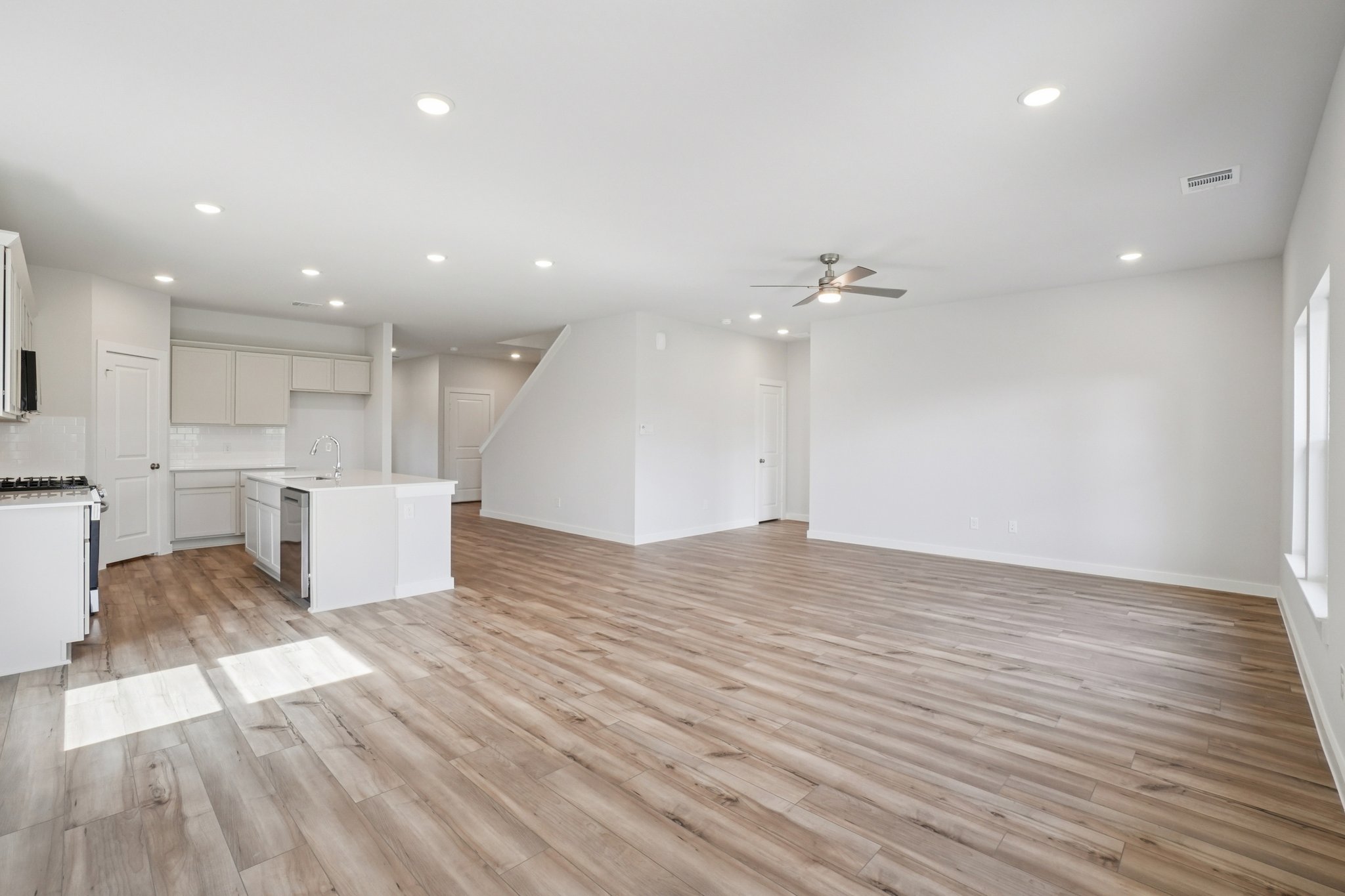 A large kitchen with white cabinets.