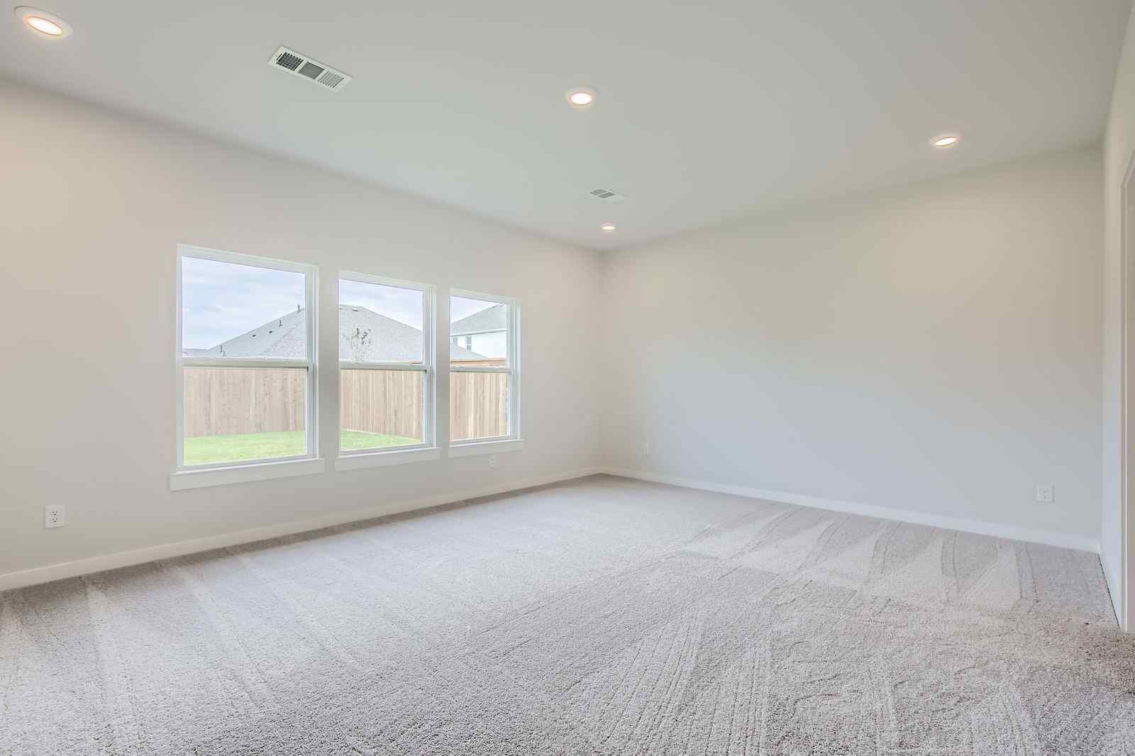 A room with a bed and windows.