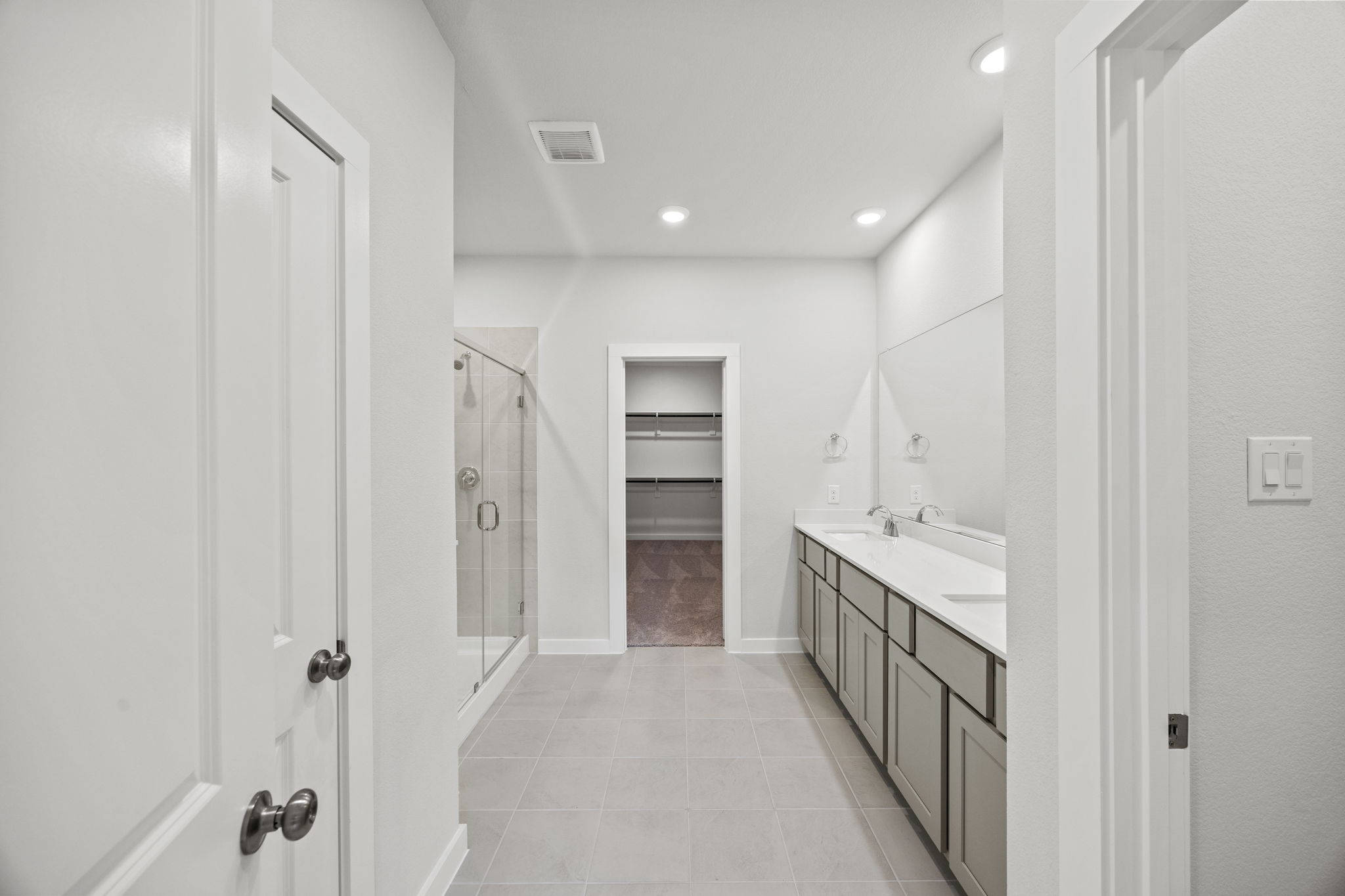 A bathroom with a sink and shower.