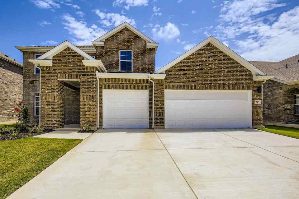 A house with garages and a driveway.