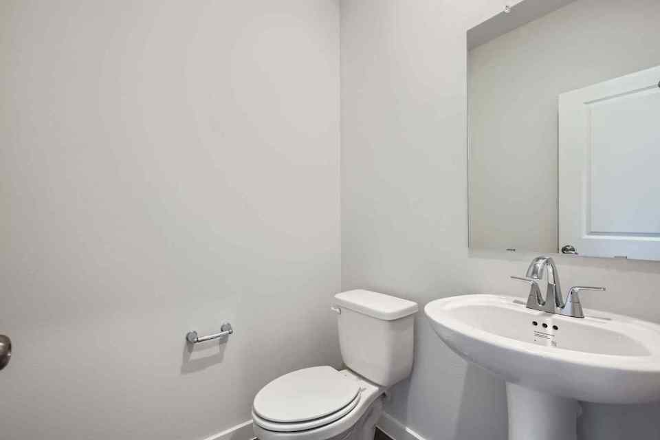 A bathroom with a toilet and sink.