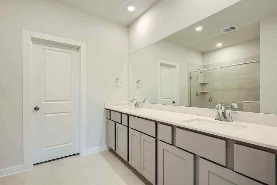 A bathroom with a large mirror.