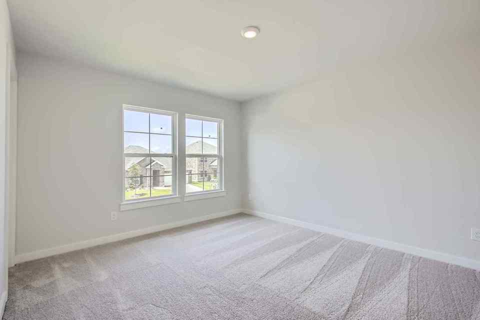 A room with a window and a carpet.