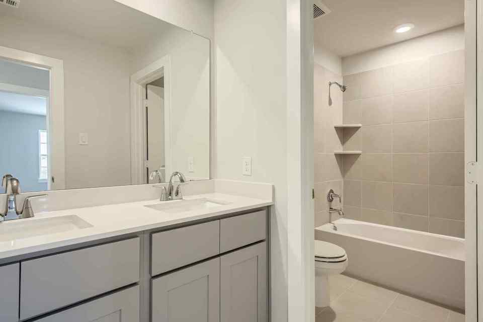 A bathroom with a tub sink and toilet.
