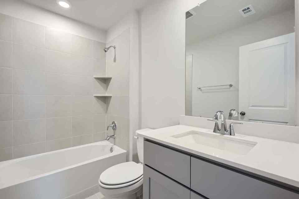 A bathroom with a tub sink and toilet.