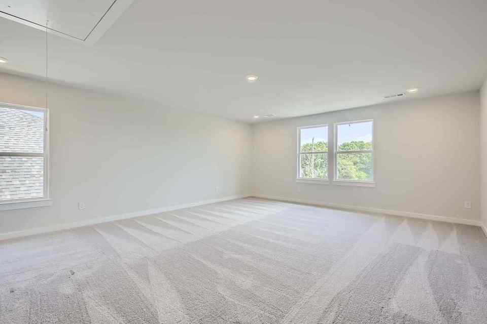 A room with a bed and a window.