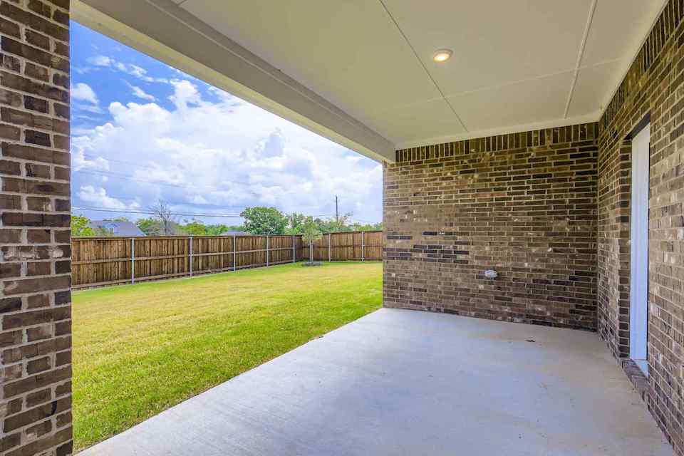A walkway between brick walls.