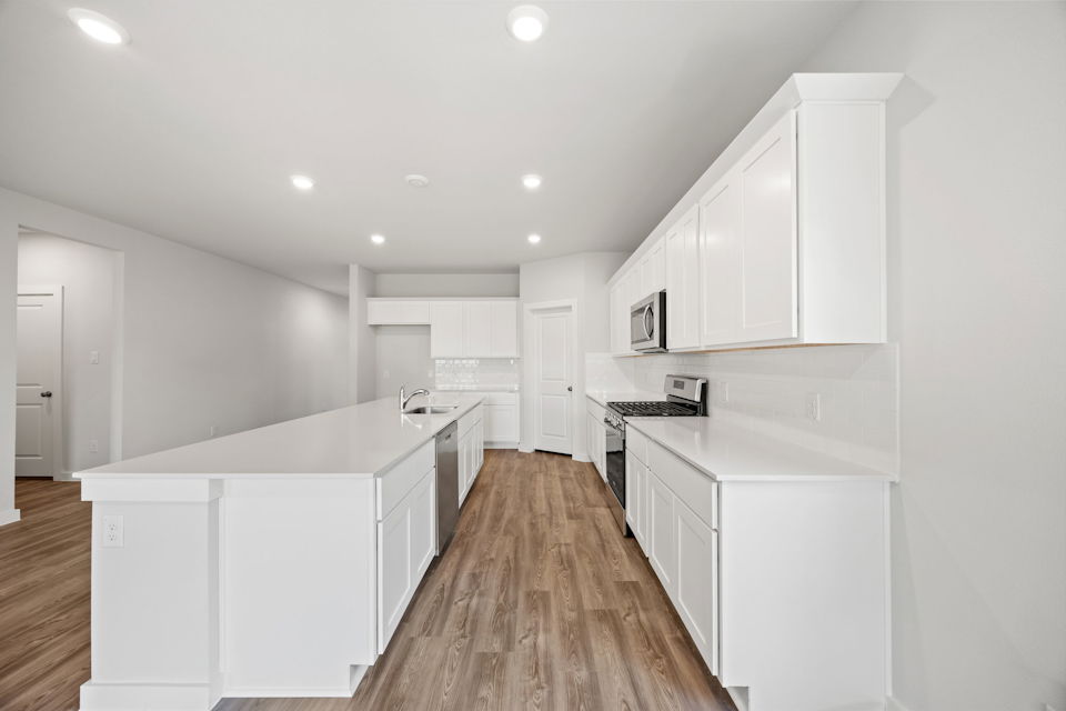 A kitchen with white cabinets.