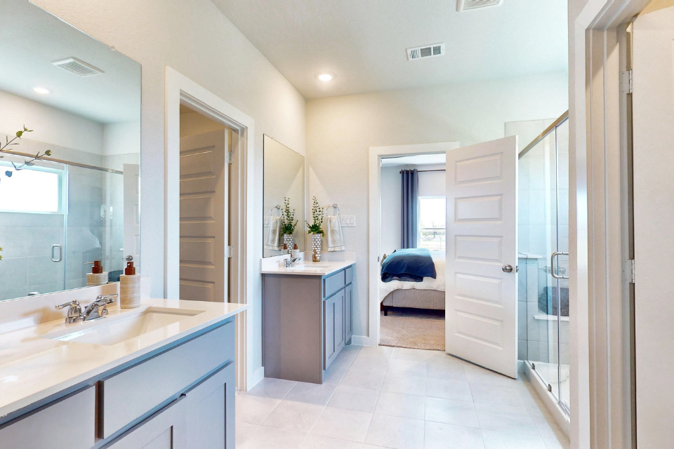 A bathroom with a sink and a bed.
