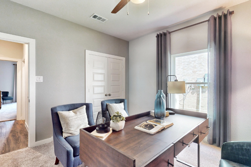 A living room with a table and chairs.
