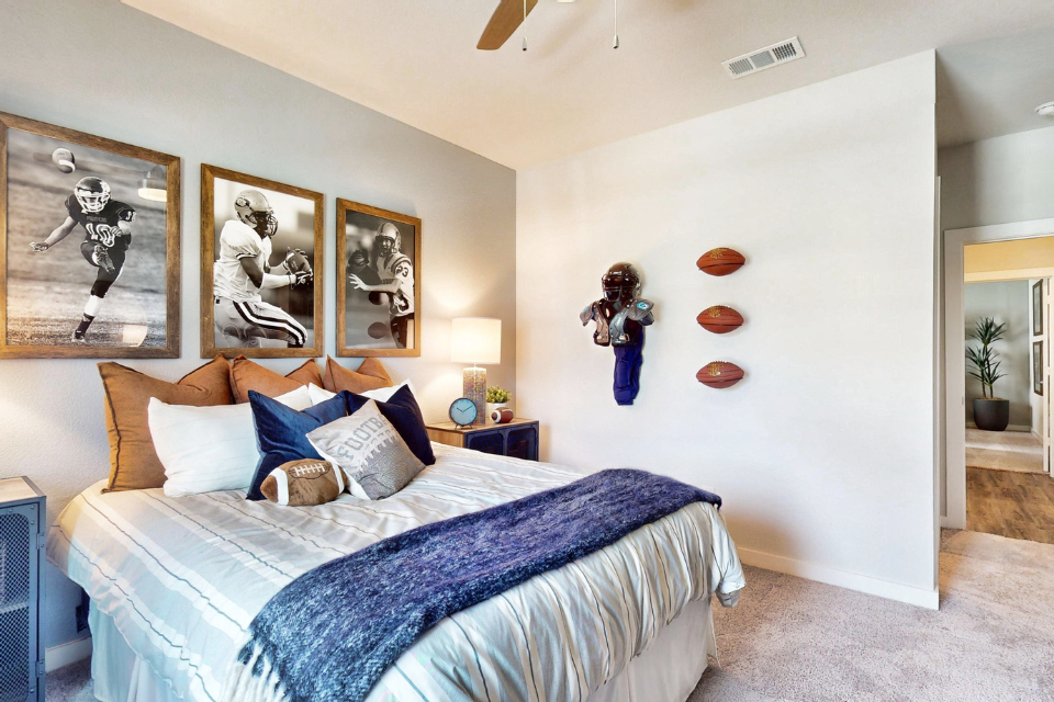 A bedroom with a bed and artwork.