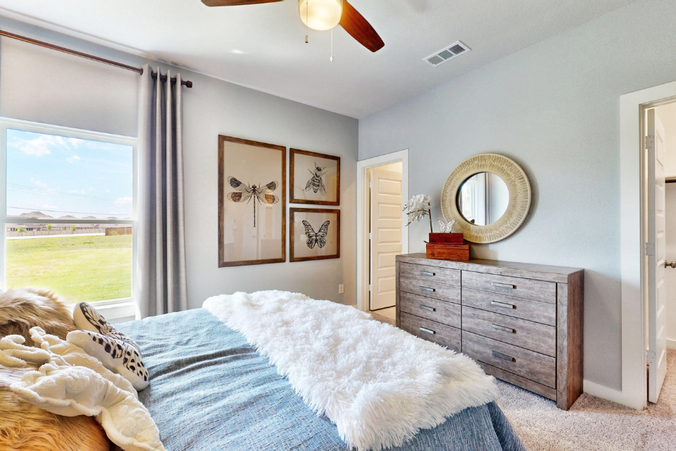 A bedroom with a large window.