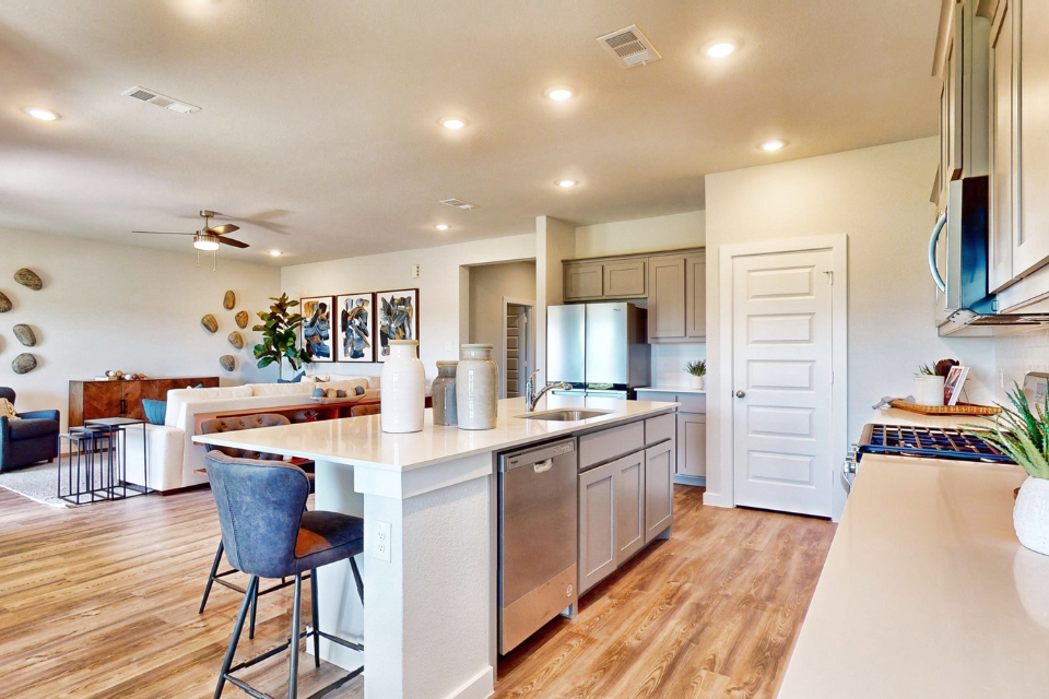 A kitchen with white cabinets.