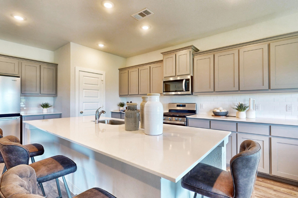 A kitchen with white cabinets.