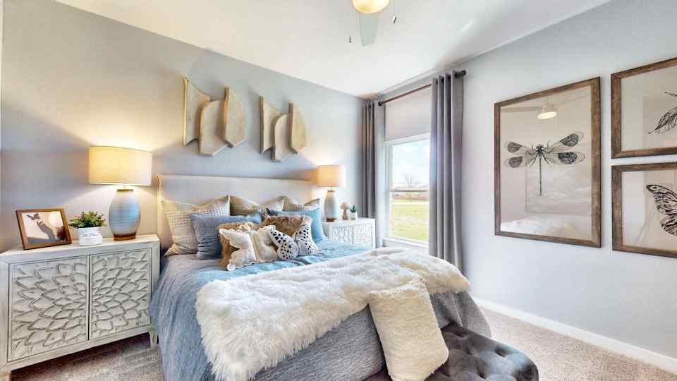 A bedroom with a bed and lamps.