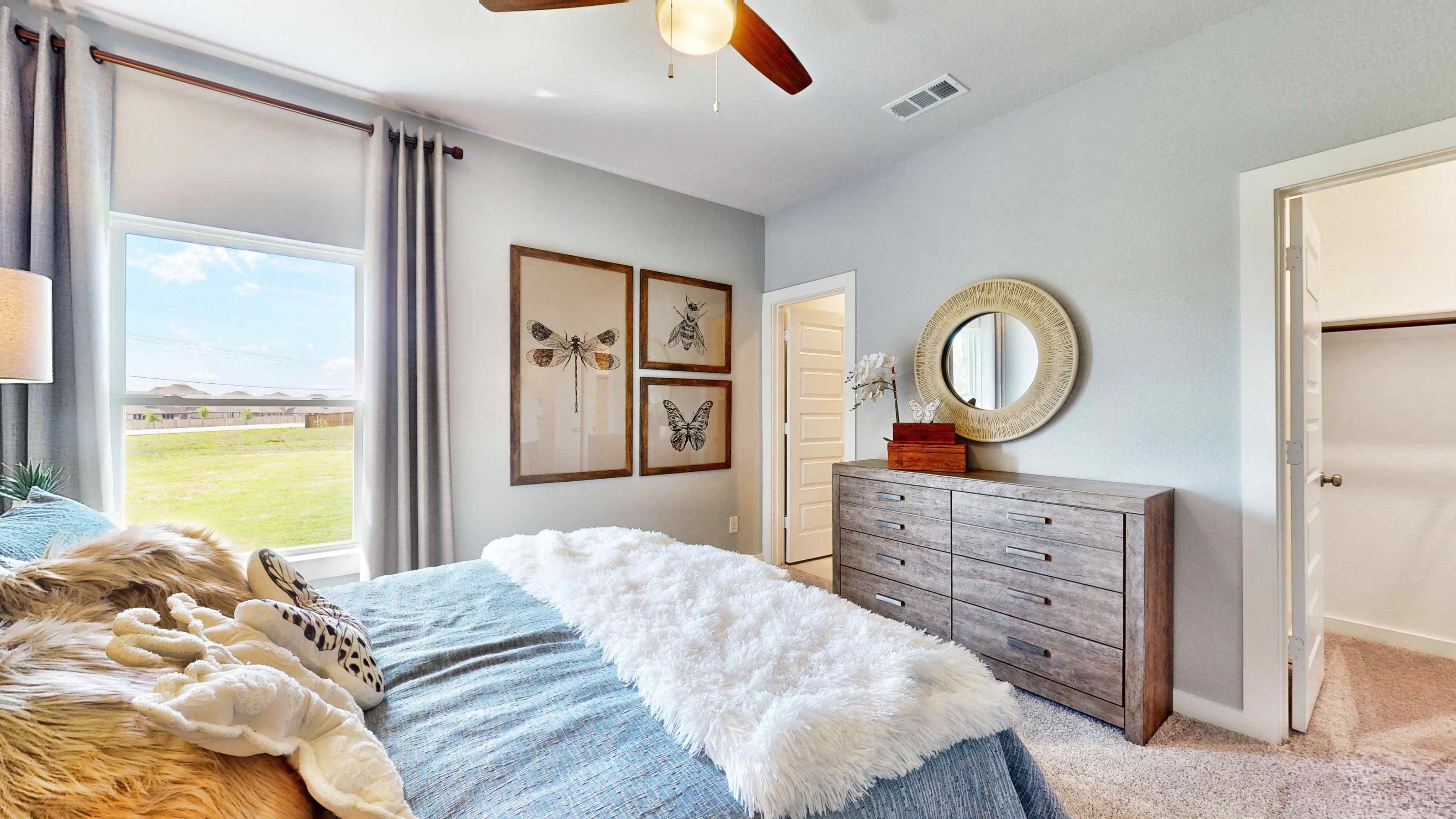 A bedroom with a large window.