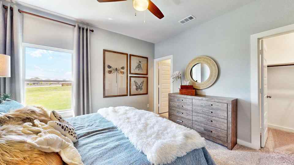 A bedroom with a large window.