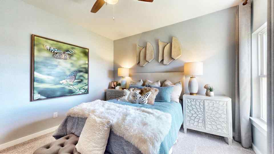 A bedroom with a large painting on the wall.