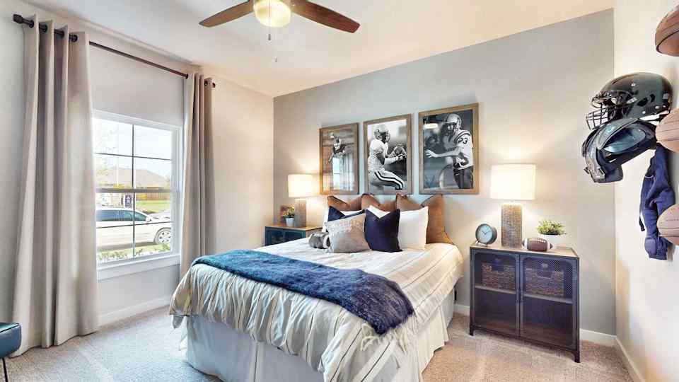 A bedroom with a large window.