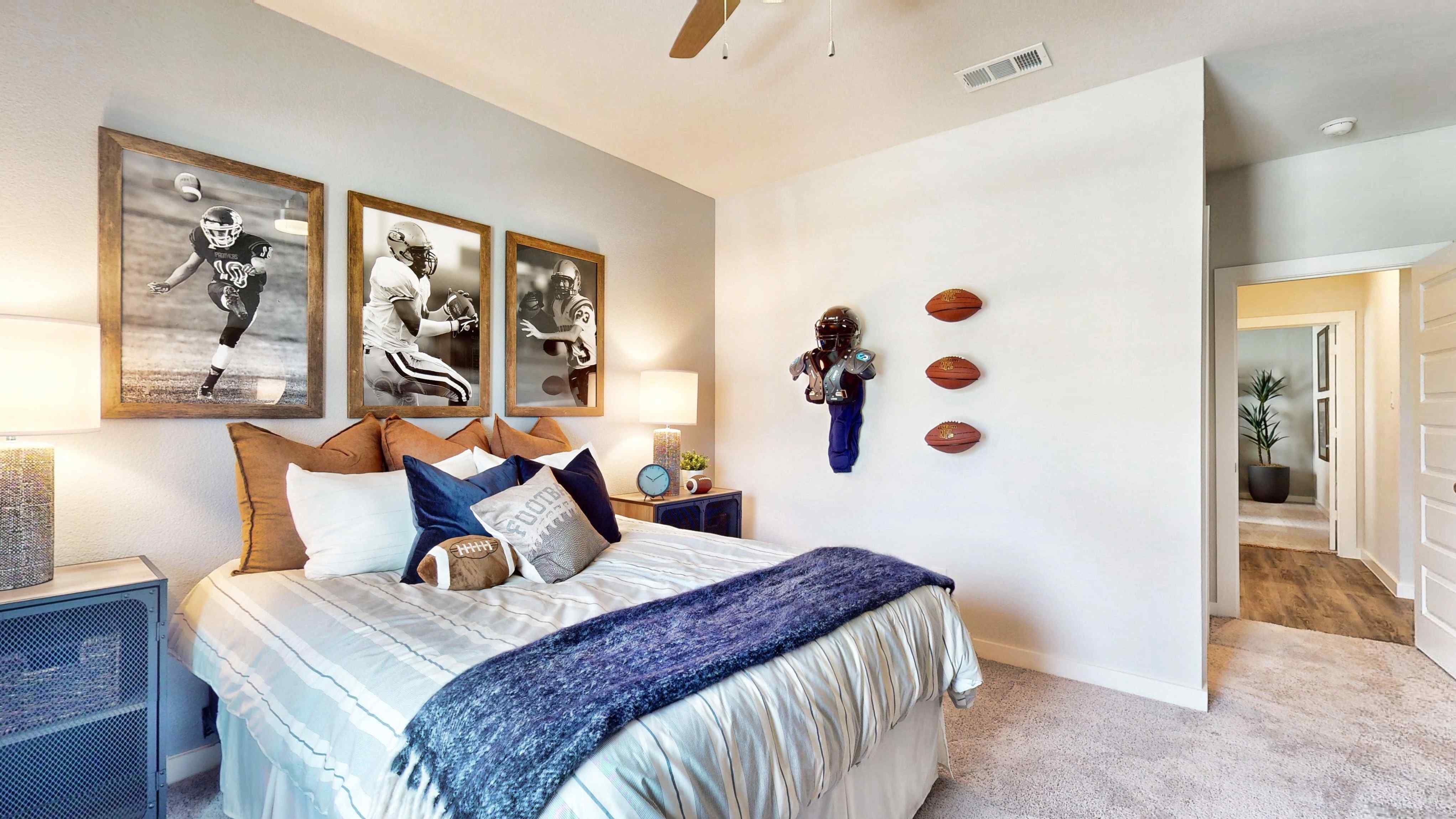 A bedroom with a bed and art on the wall.