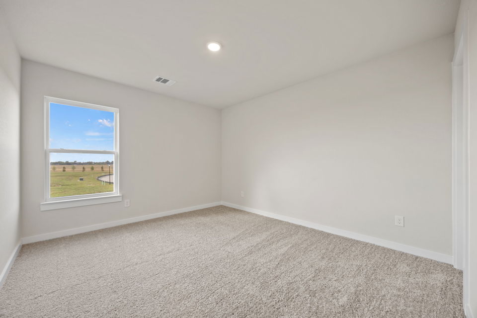 A room with a window and carpet.