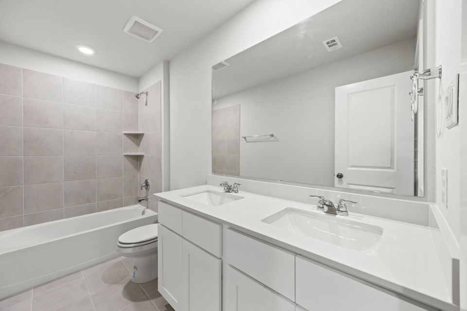 A bathroom with a tub sink and toilet.