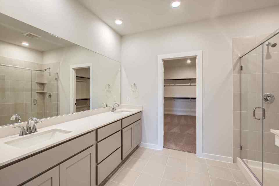 A bathroom with a shower and sink.