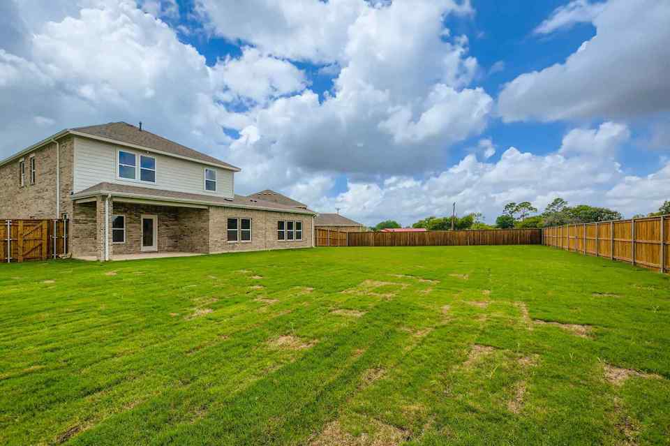 A house with a fence and grass.