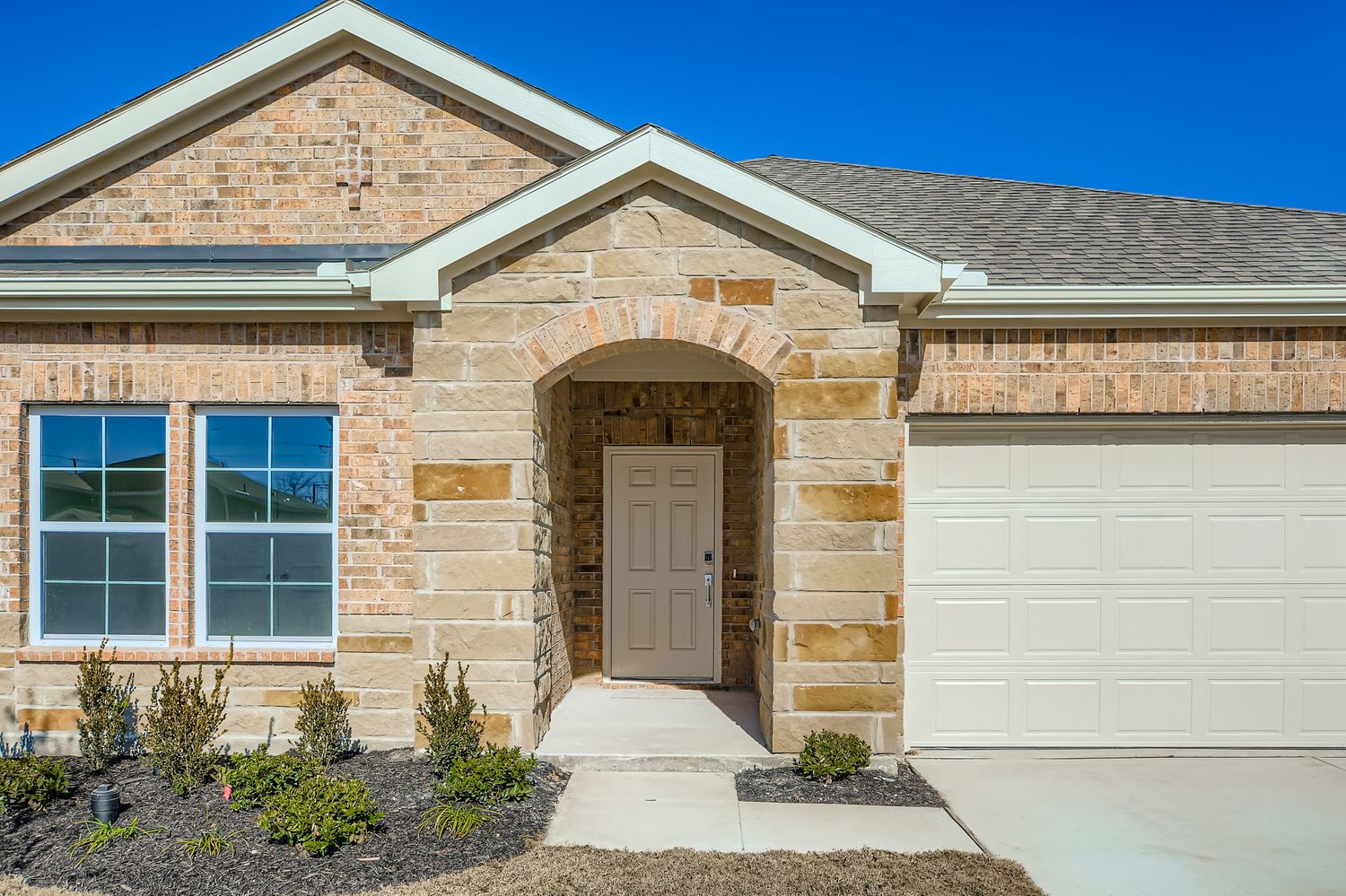 A house with a garage and a garage door.