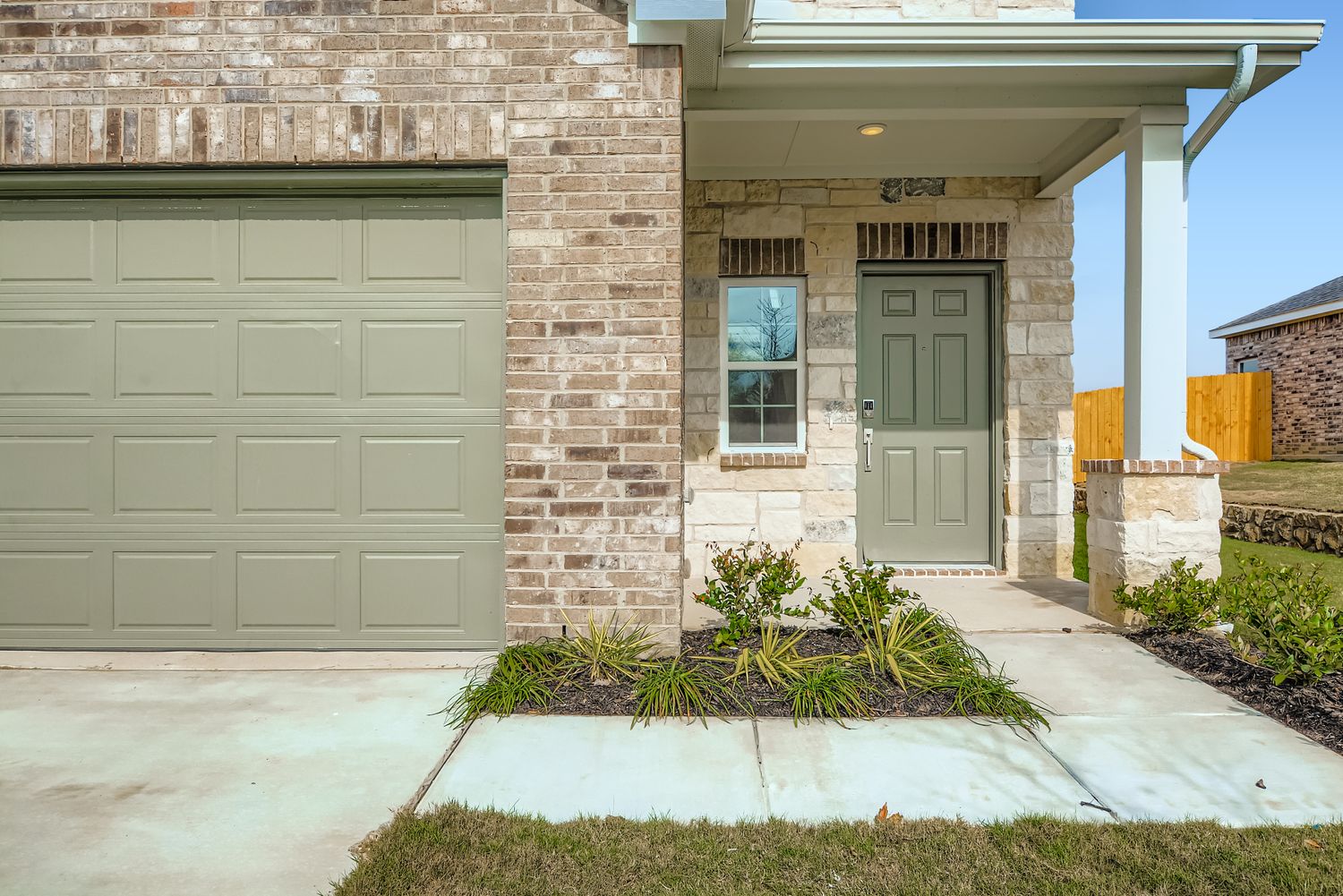 A house with a garage and a door.