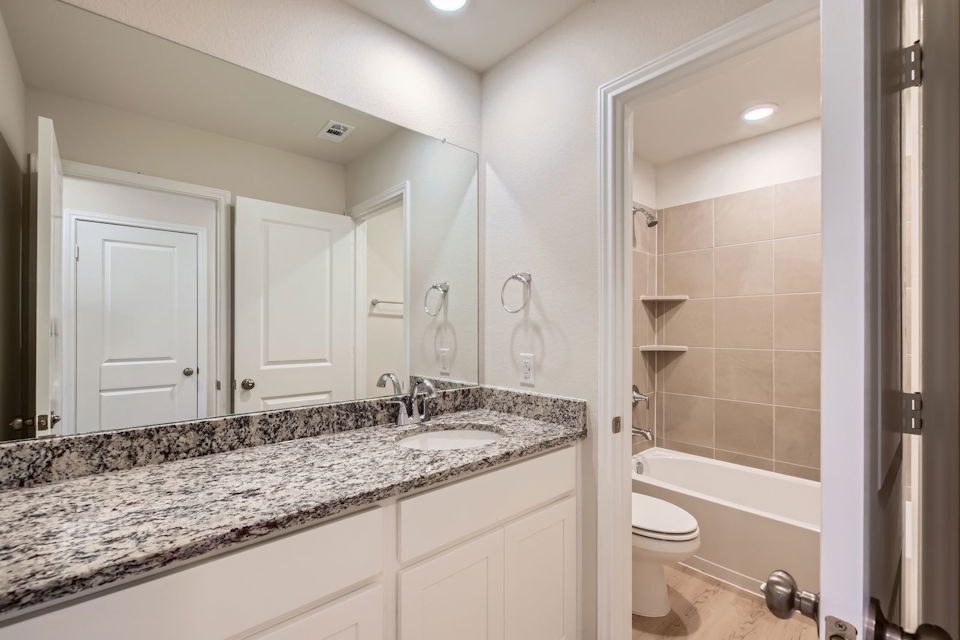 A bathroom with a marble countertop.