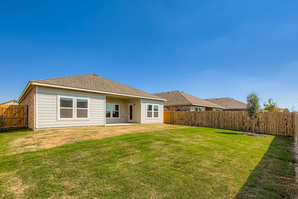 A house with a fence and grass.