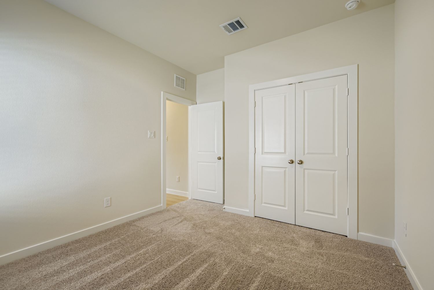 A hallway with white doors.