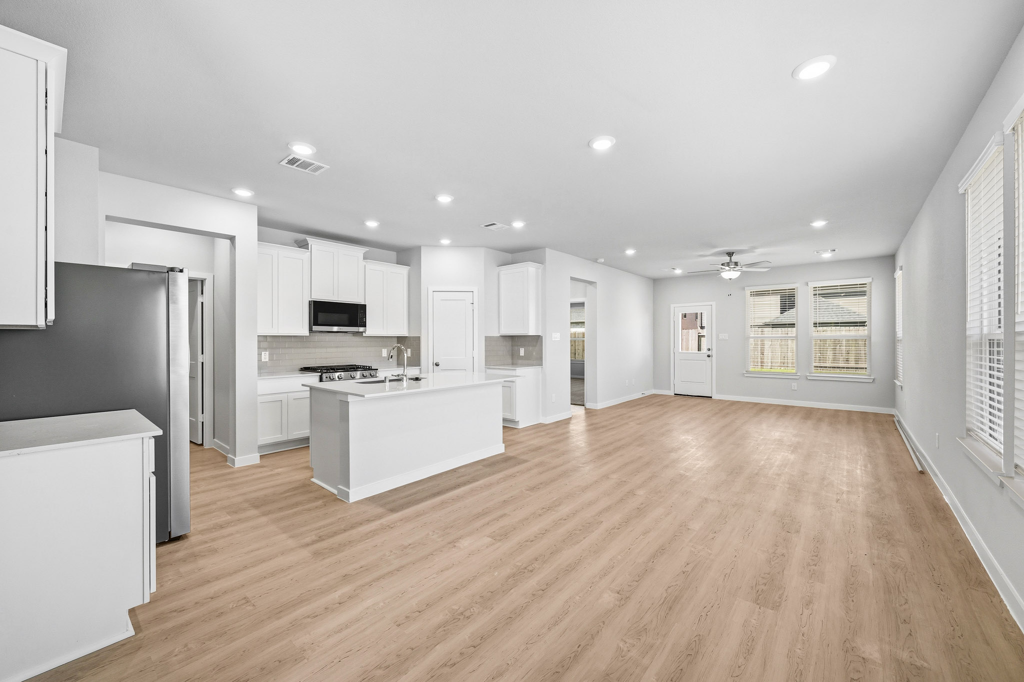 A kitchen with white cabinets.