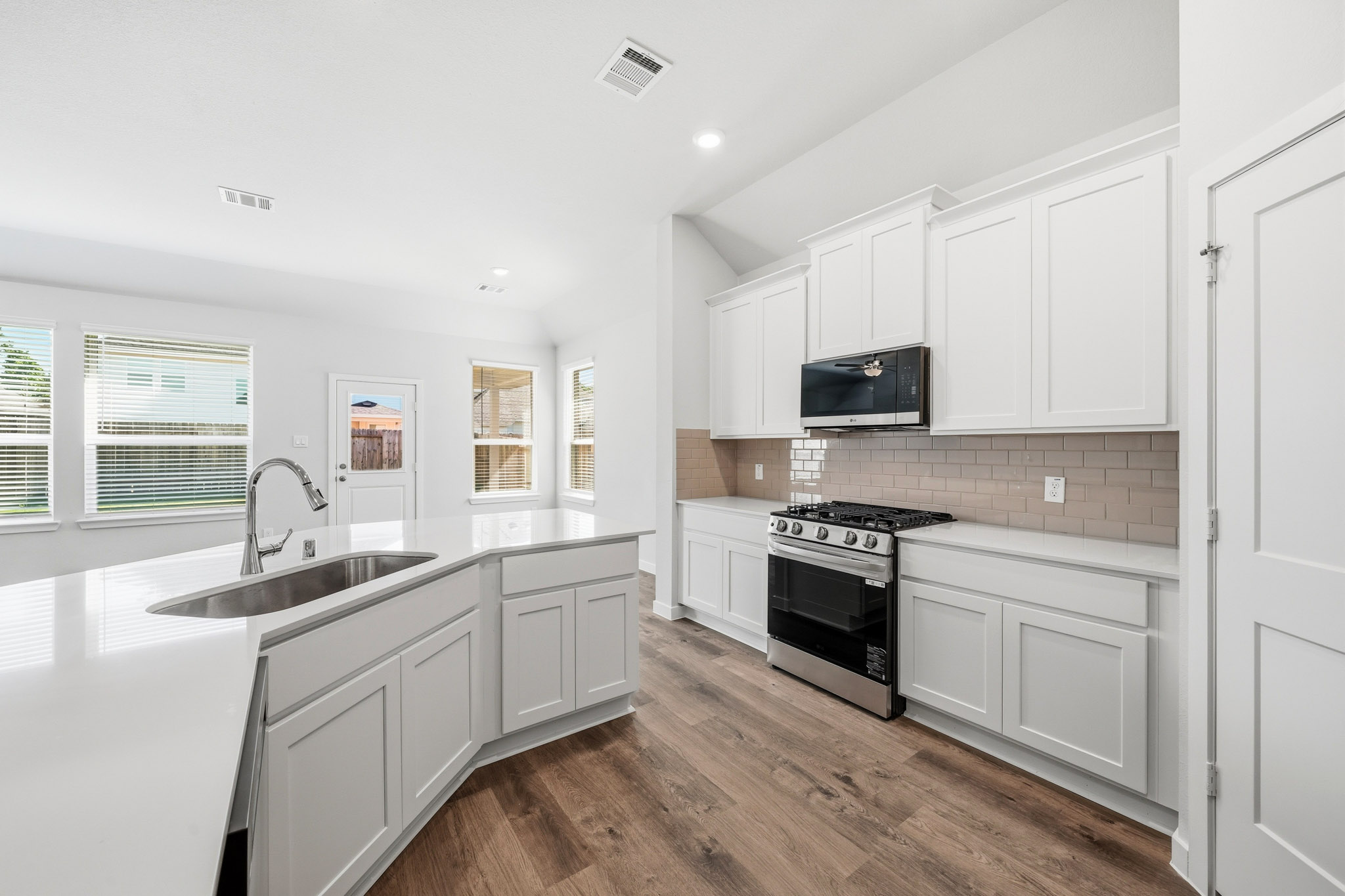 A kitchen with white cabinets.