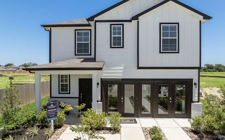 A house with a sign in front.