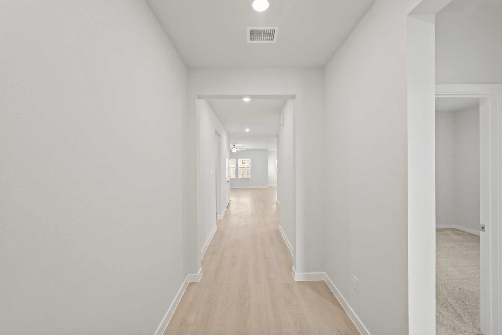A long hallway with white walls.